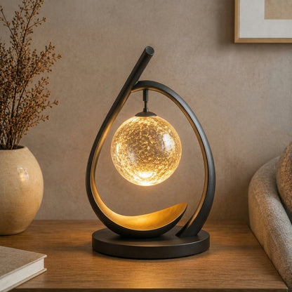 Nuvorly™ HaloArc Suspended Orb Table Lamp – Sculptural Black Frame Accent Light with Textured Glass Globe & Warm Ambient Glow